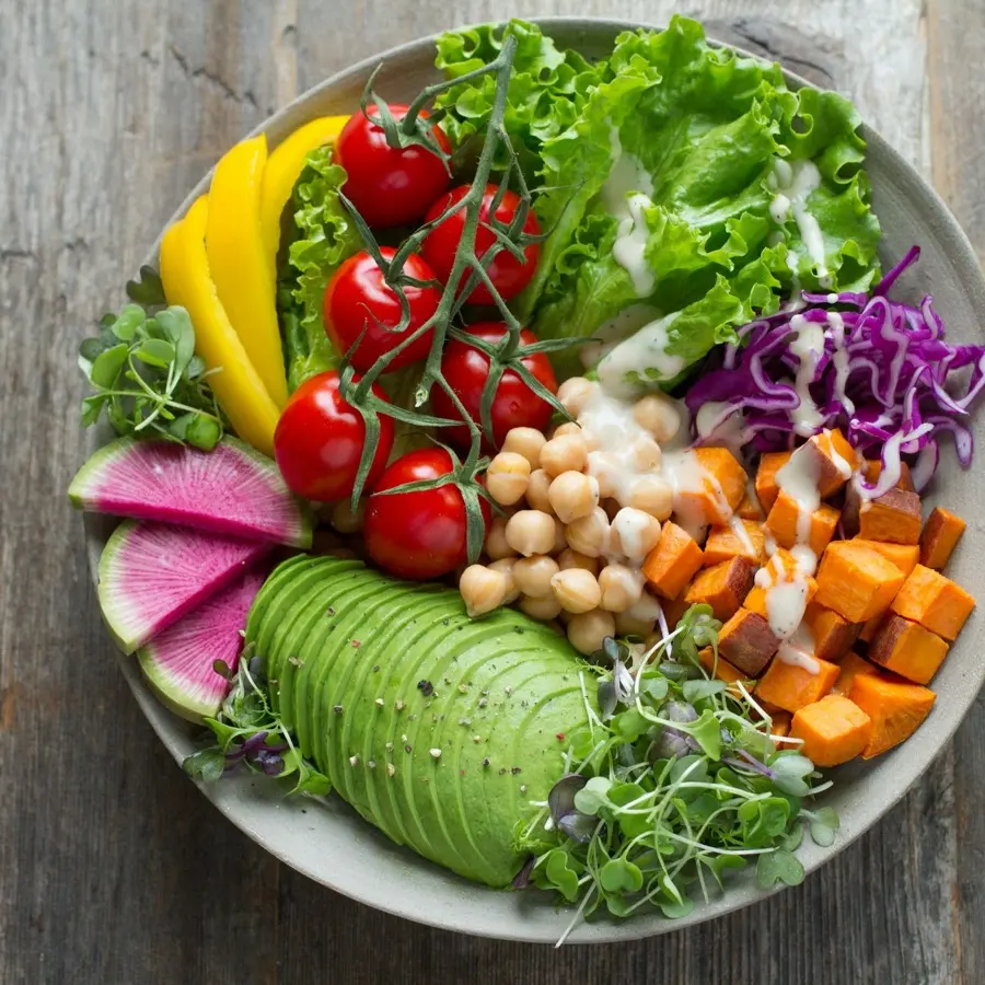 A Mediterranean feta salad bowl with tomatoes, olives, cucumber and greens